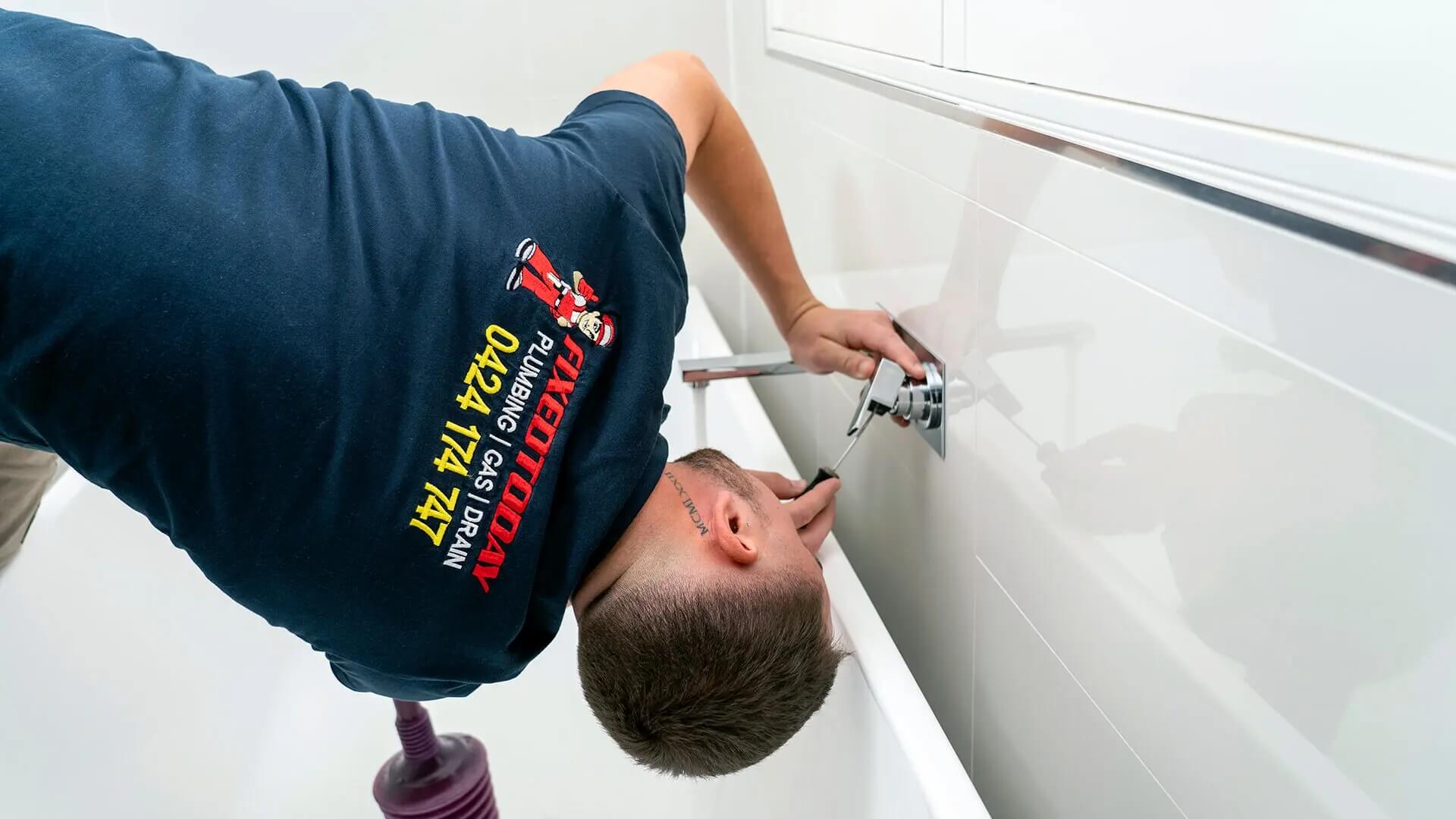 Plumber repairing taps